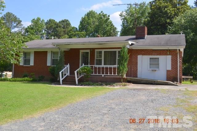 4621 Redwood Road Durham, NC 27704 - Photo 1 of 13 a backyard of a house with yard and outdoor seating