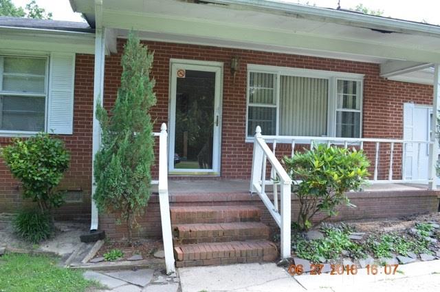4621 Redwood Road Durham, NC 27704 - Photo 5 of 13 a front view of a house with plants and garden