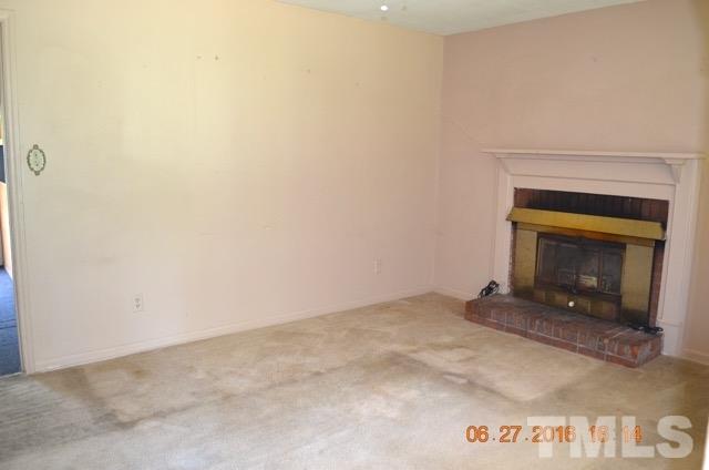 4621 Redwood Road Durham, NC 27704 - Photo 6 of 13 a view of an empty room with a fireplace