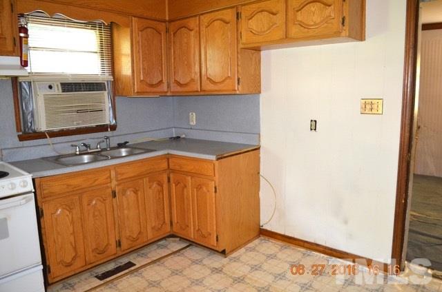 4621 Redwood Road Durham, NC 27704 - Photo 8 of 13 a utility room with granite countertop cabinets washer and dryer