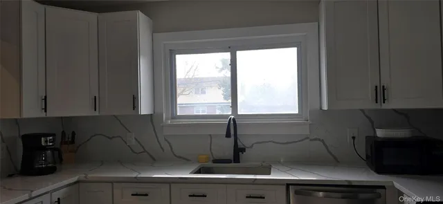 a kitchen with a sink and cabinets