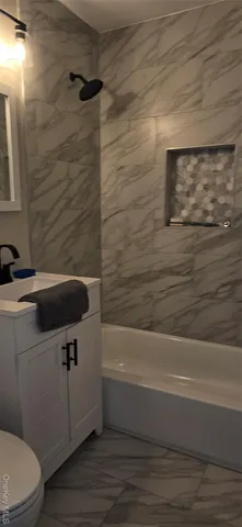 a bathroom with a sink a toilet and bathtub