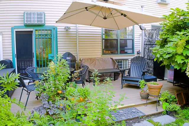 a backyard of a house with table and chairs