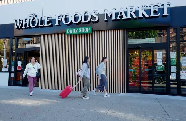 a view of street with a building and a people on a street