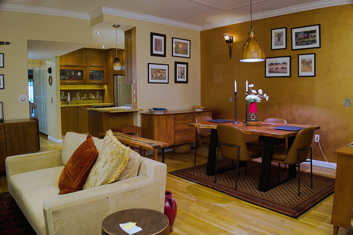 a living room with furniture and painting on the wall