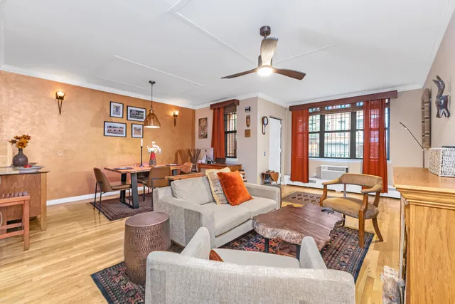 a living room with furniture and painting on the wall
