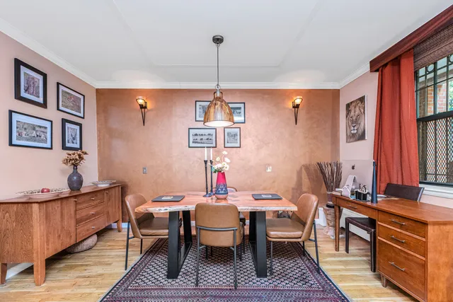 a living room with furniture a fireplace and a chandelier