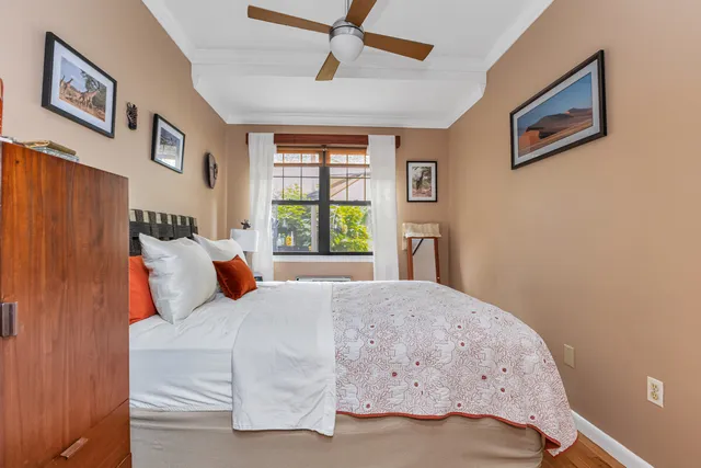 a bedroom with a bed next to a window