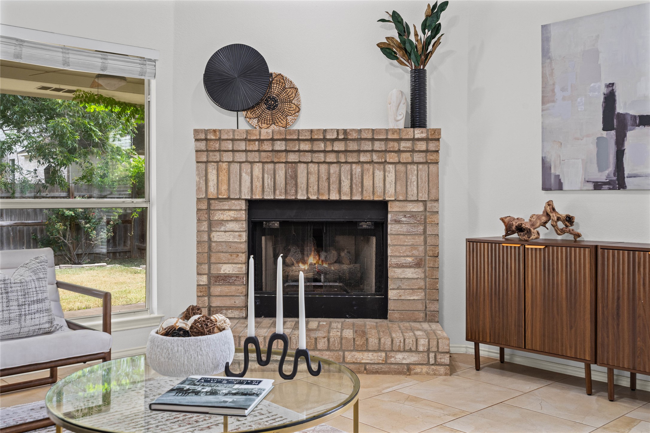 2920 Warwick Way Austin, TX 78748 - Photo 12 of 36 A cozy gathering spot with a brick fireplace, inviting warmth and conversation
