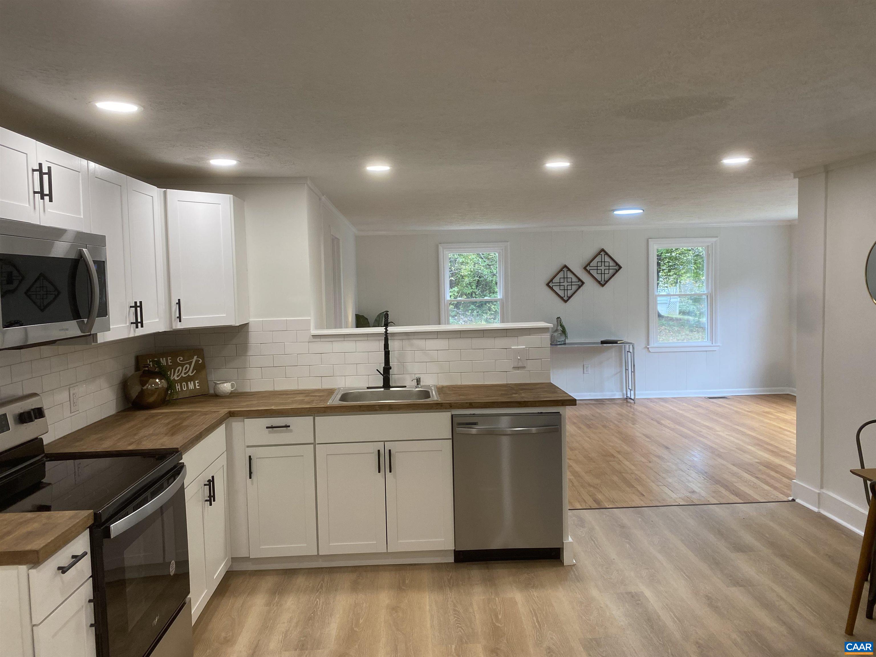 7548 Laurel Road Shipman, VA 22971 - Photo 3 of 10 a kitchen with stainless steel appliances granite countertop a sink a stove top oven a counter space and cabinets