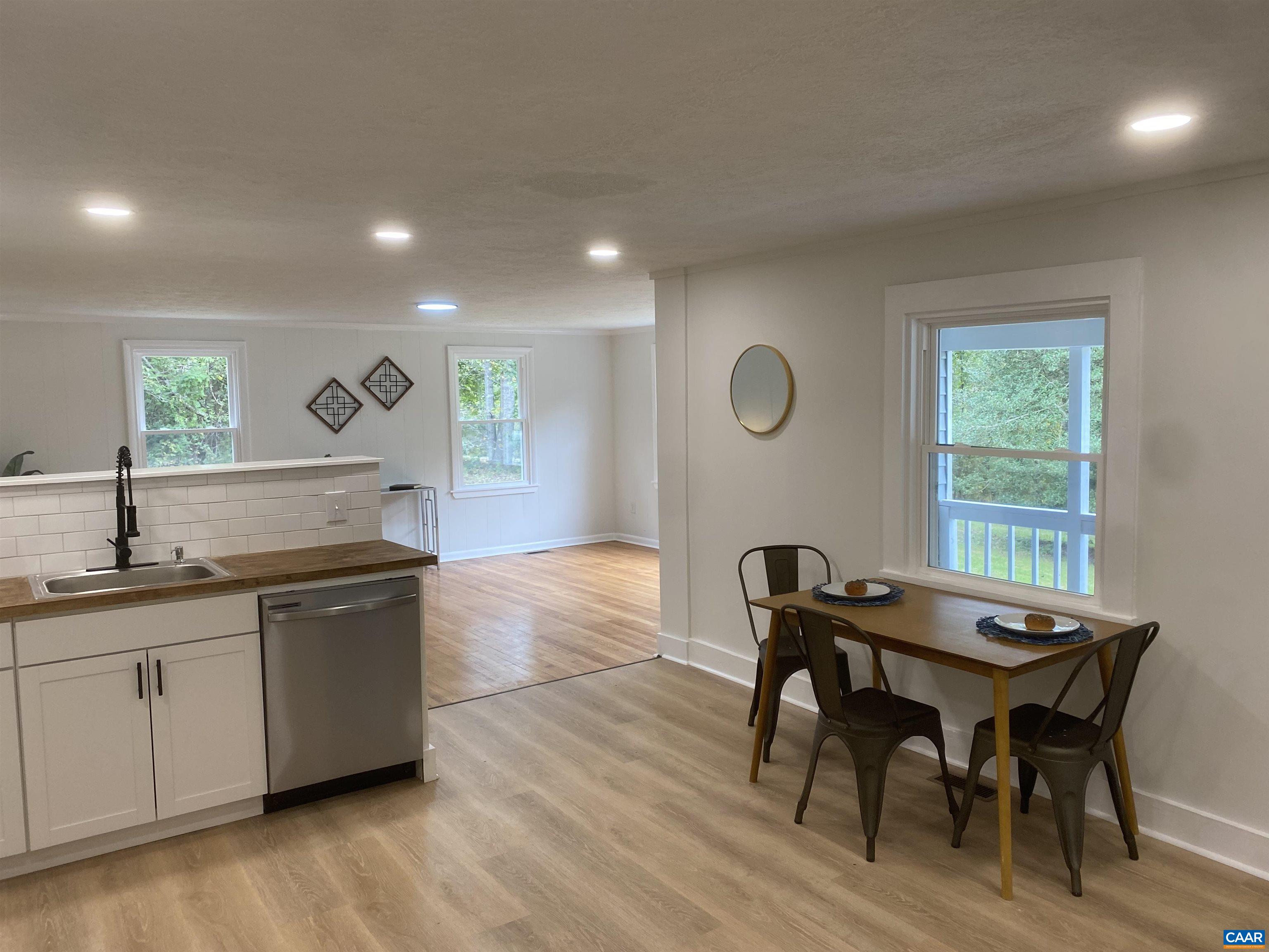 7548 Laurel Road Shipman, VA 22971 - Photo 4 of 10 a kitchen with granite countertop a dining table chairs and wooden floor