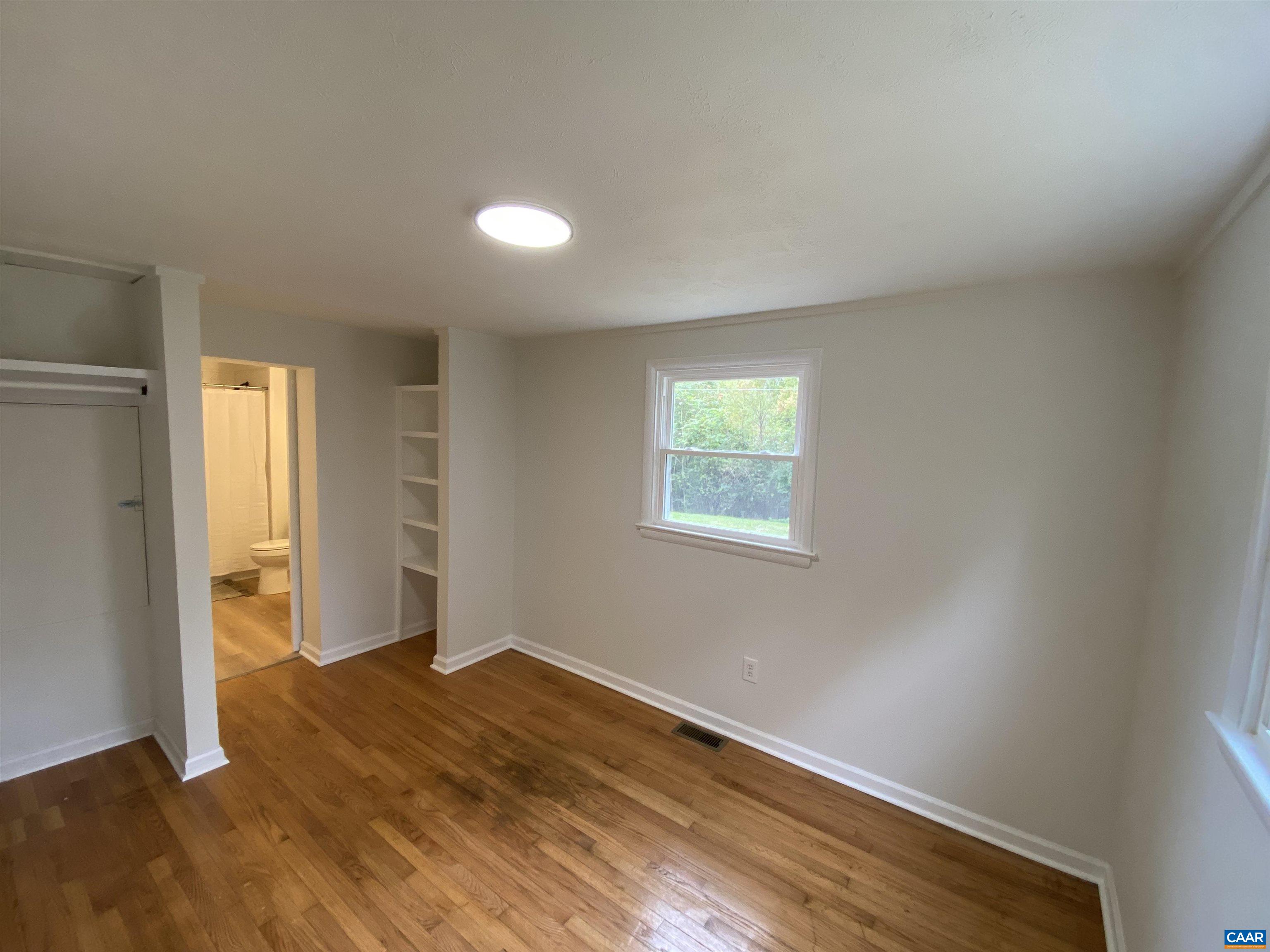 7548 Laurel Road Shipman, VA 22971 - Photo 6 of 10 an empty room with wooden floor and windows