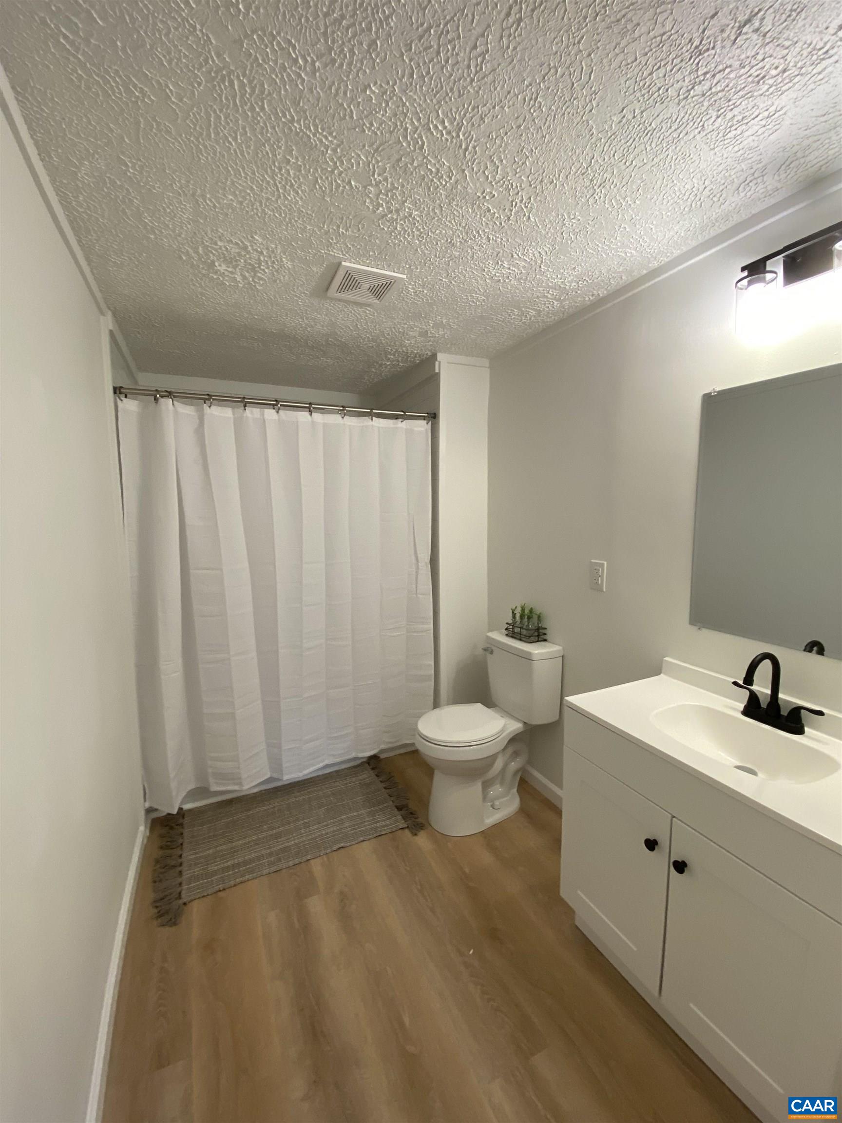 7548 Laurel Road Shipman, VA 22971 - Photo 7 of 10 a bathroom with a sink a toilet and vanity