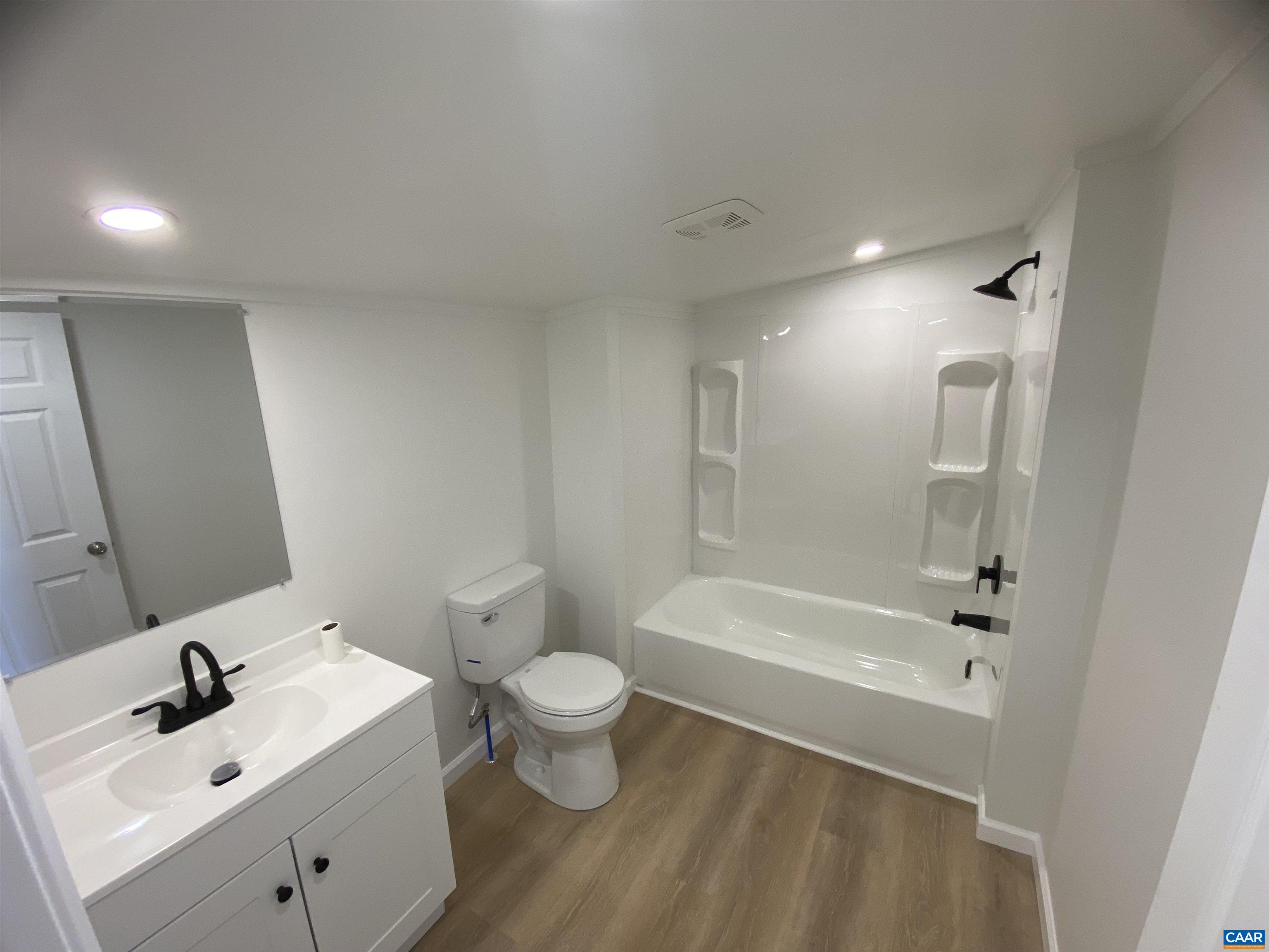 7548 Laurel Road Shipman, VA 22971 - Photo 10 of 10 a bathroom with a sink mirror toilet and bathtub