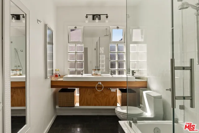 a bathroom with a tub sink and mirror