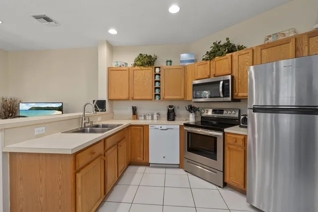 a kitchen with a sink dining table and chairs