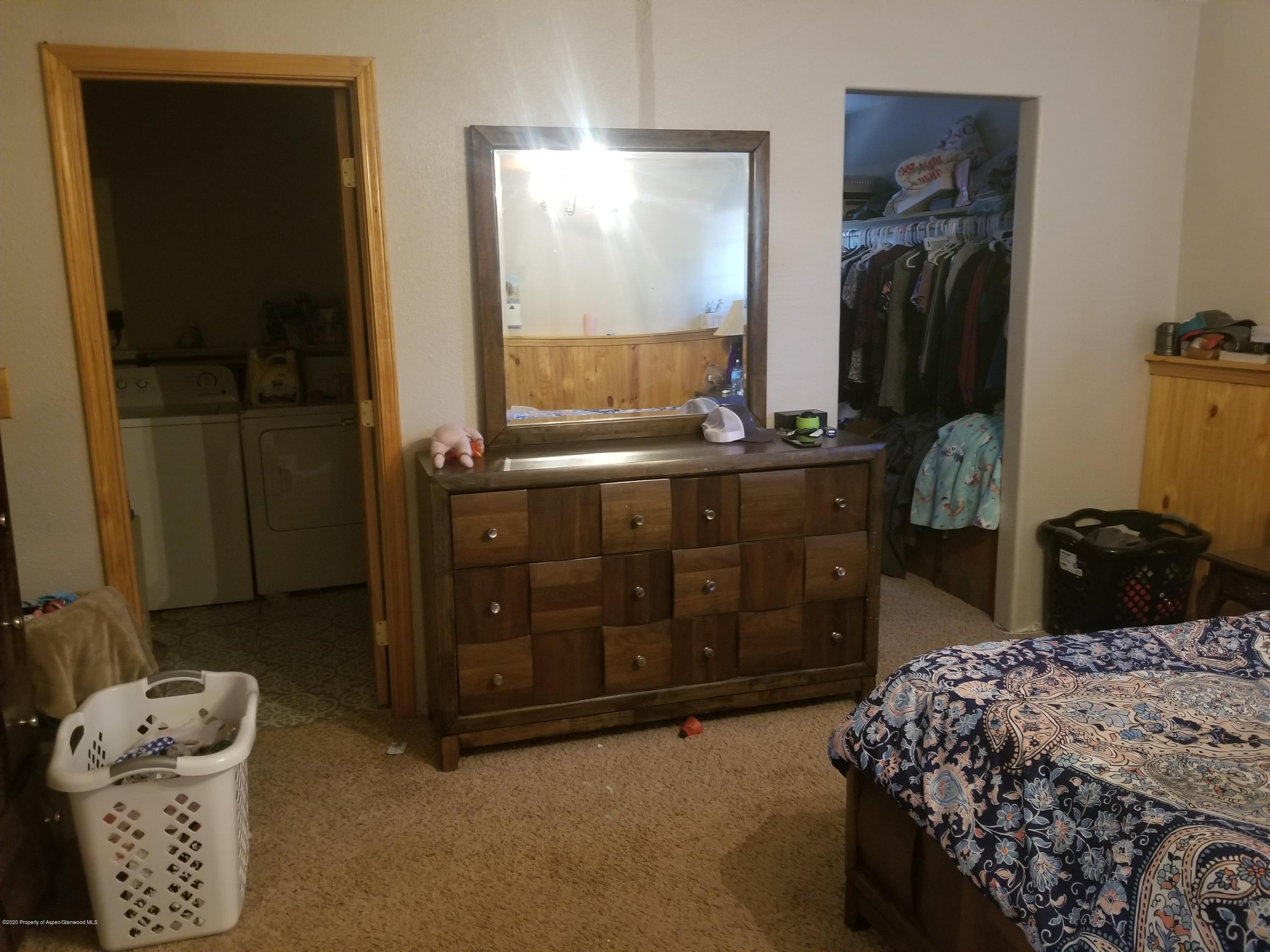 783 Cedar Court Rifle, CO 81650 - Photo 11 of 17 a bedroom with a bed and a mirror