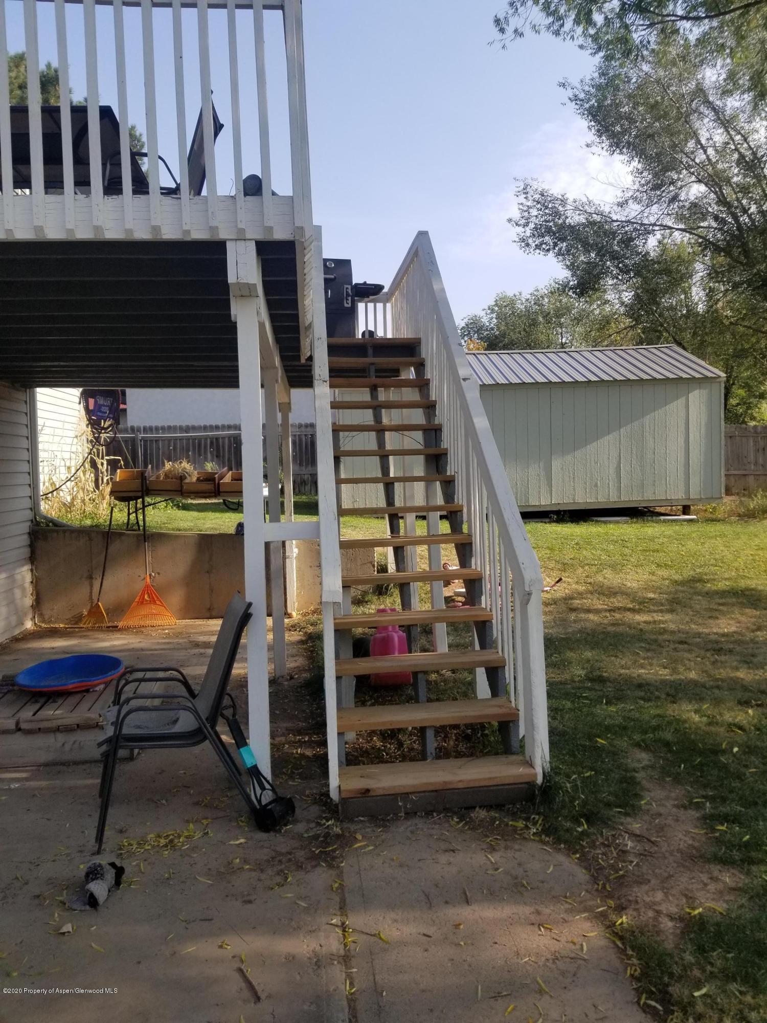 783 Cedar Court Rifle, CO 81650 - Photo 17 of 17 a view of a balcony with chairs and wooden fence