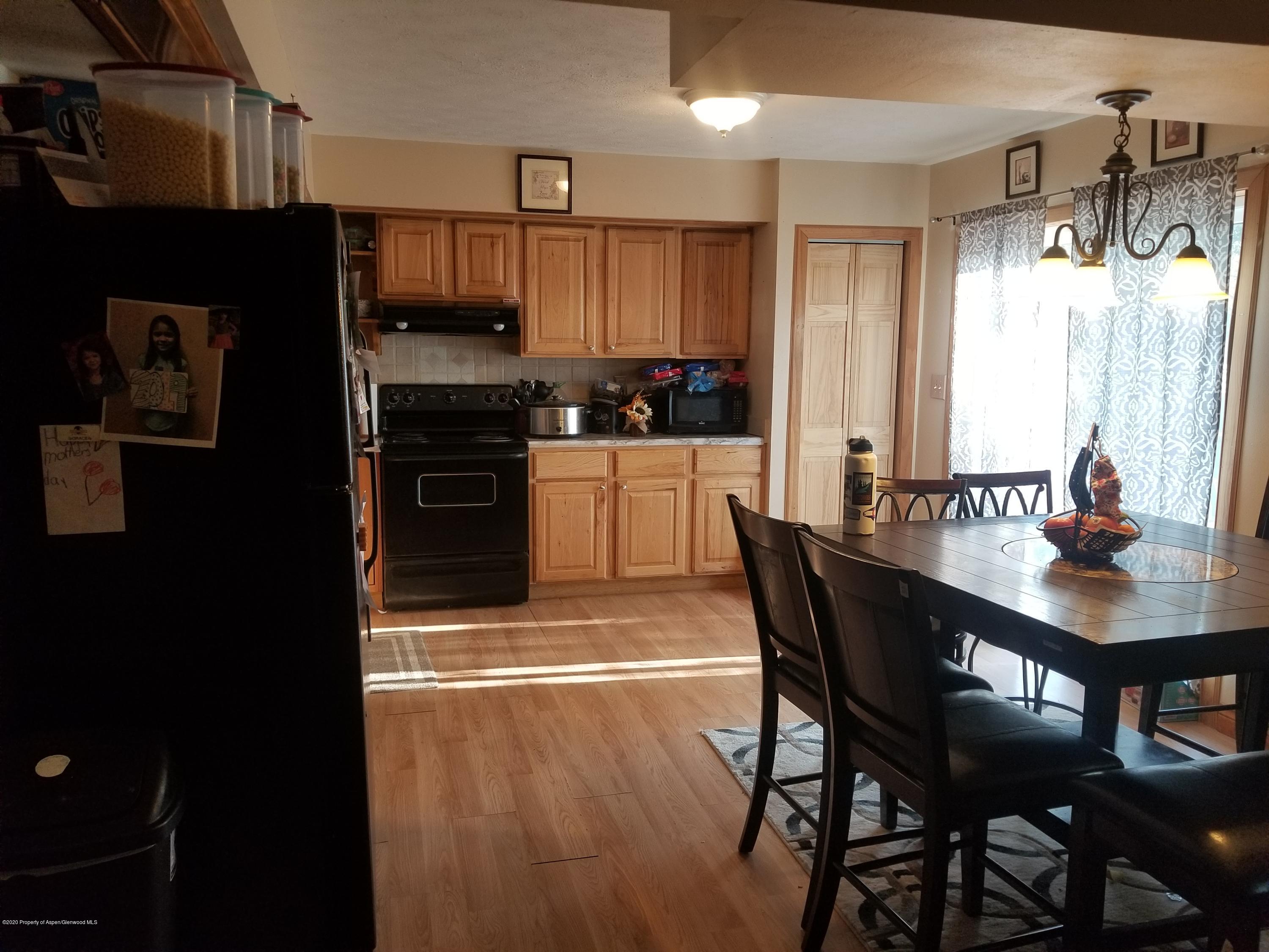 783 Cedar Court Rifle, CO 81650 - Photo 4 of 17 a kitchen with a wooden table and chairs