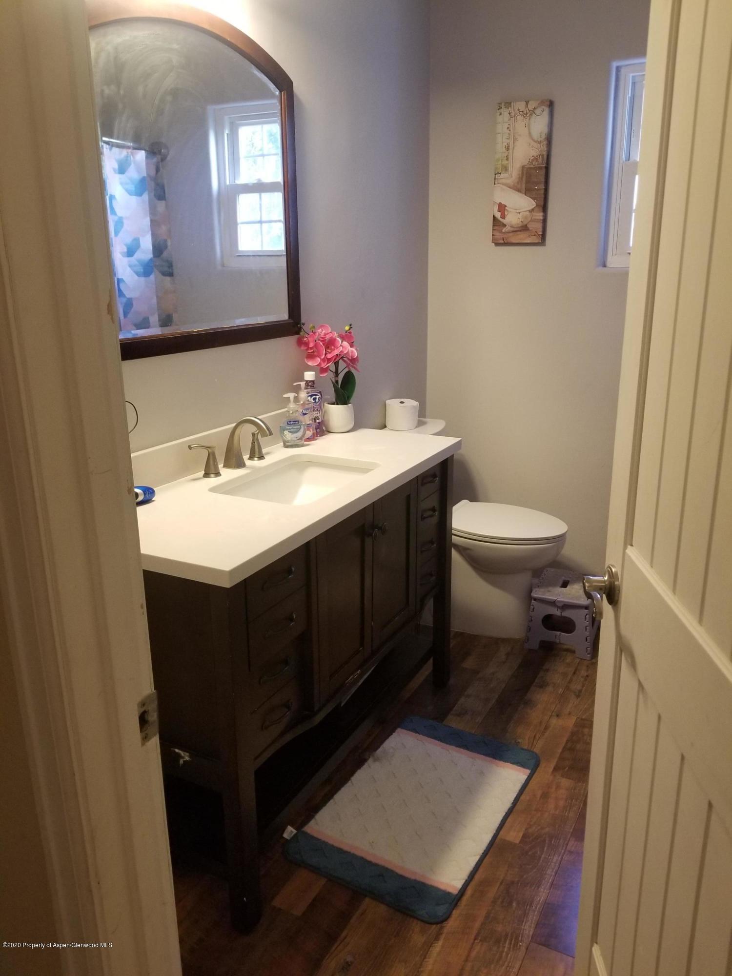 783 Cedar Court Rifle, CO 81650 - Photo 9 of 17 a bathroom with a sink toilet and a mirror