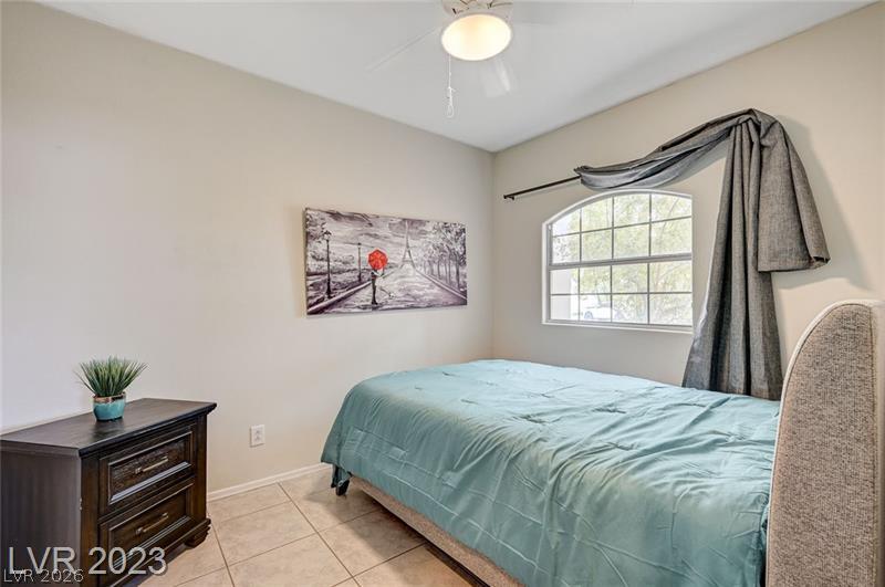 987 Cutter Street Henderson, NV 89011 - Photo 11 of 17 A window with arch and grid detailing illuminates this comfortable, private bedroom space.