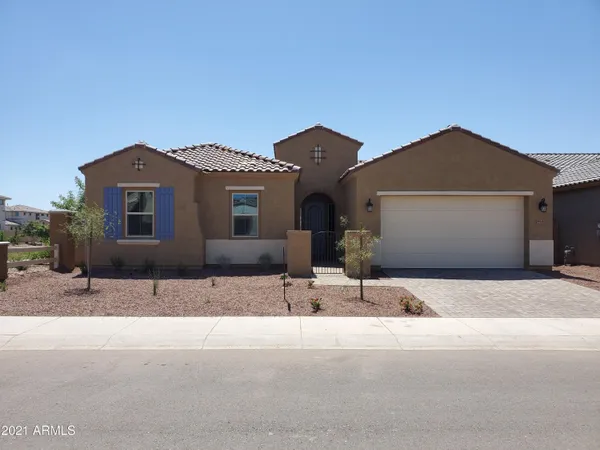a front view of a house with a road
