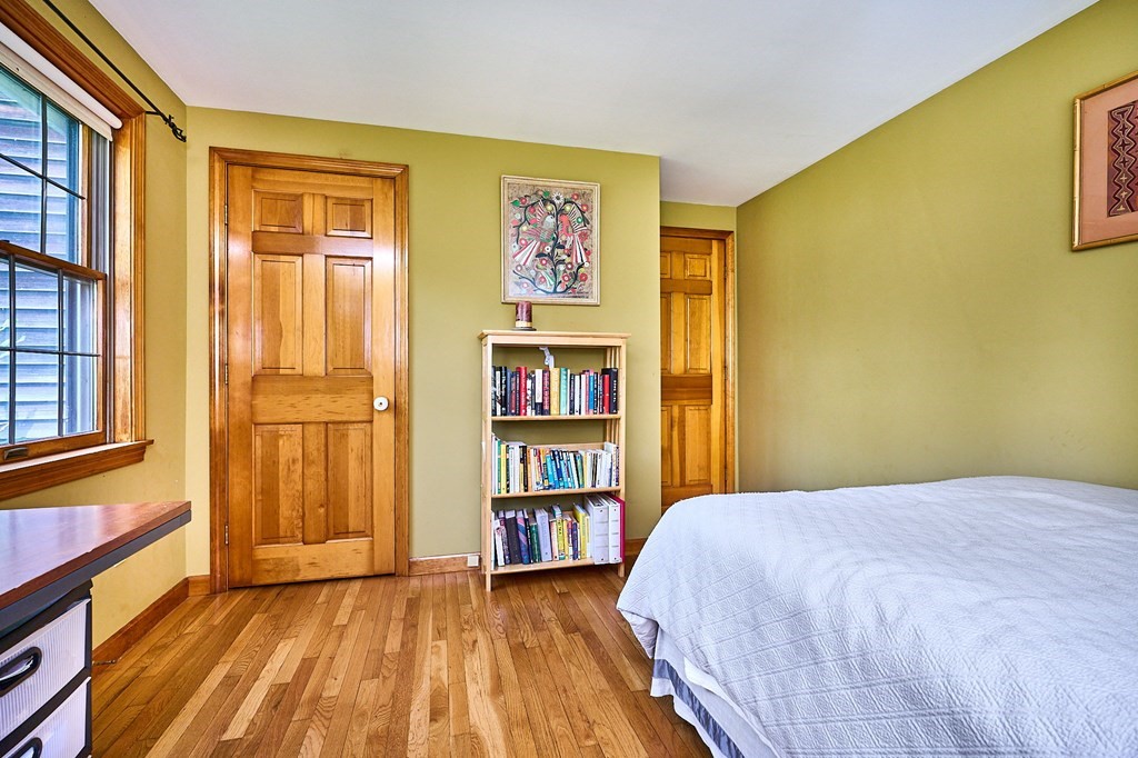 410 Hadley Road Sunderland, MA 01375 - Photo 12 of 32 a bedroom with a bed and a book shelf