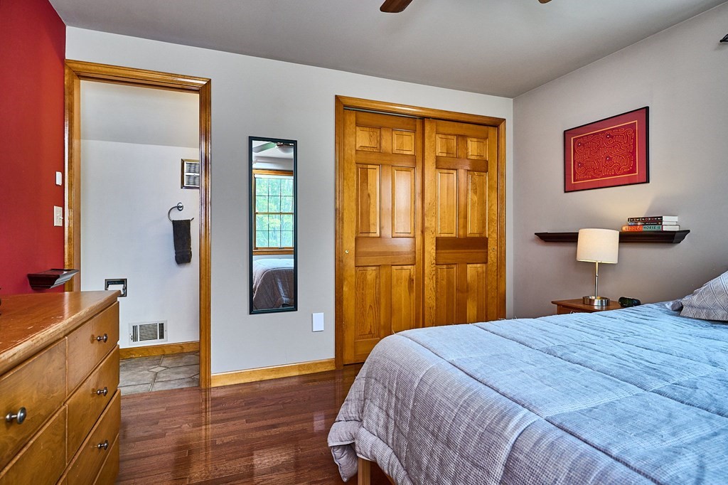 410 Hadley Road Sunderland, MA 01375 - Photo 14 of 32 a bedroom with a bed and wooden floor