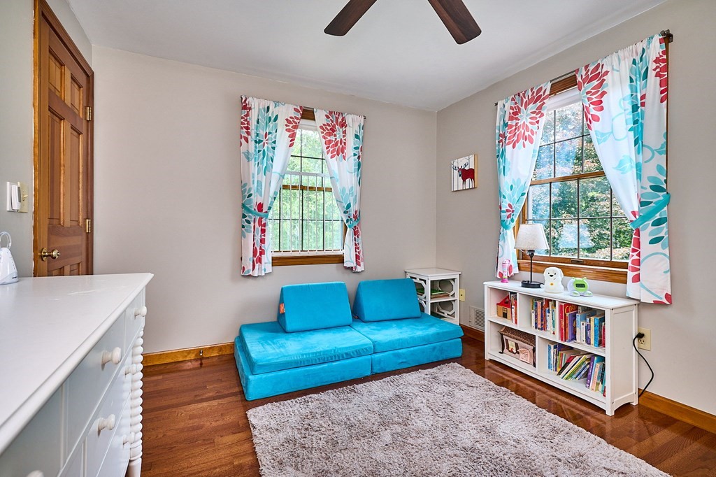 410 Hadley Road Sunderland, MA 01375 - Photo 17 of 32 a living room with baby crib furniture and a book shelf