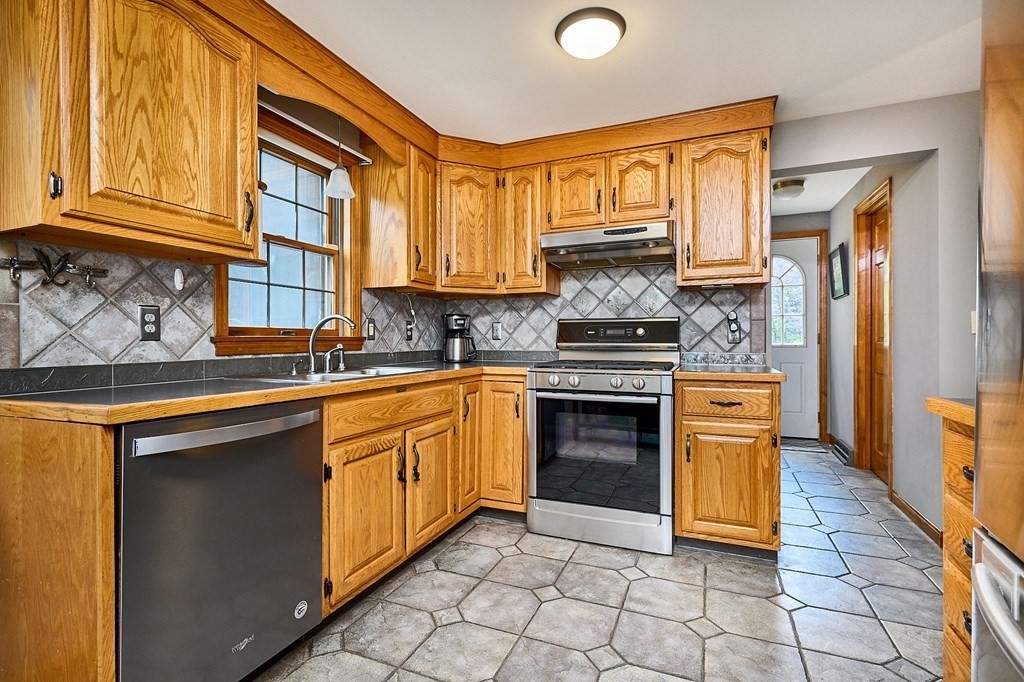410 Hadley Road Sunderland, MA 01375 - Photo 5 of 32 a kitchen with stainless steel appliances granite countertop a stove a sink and a refrigerator