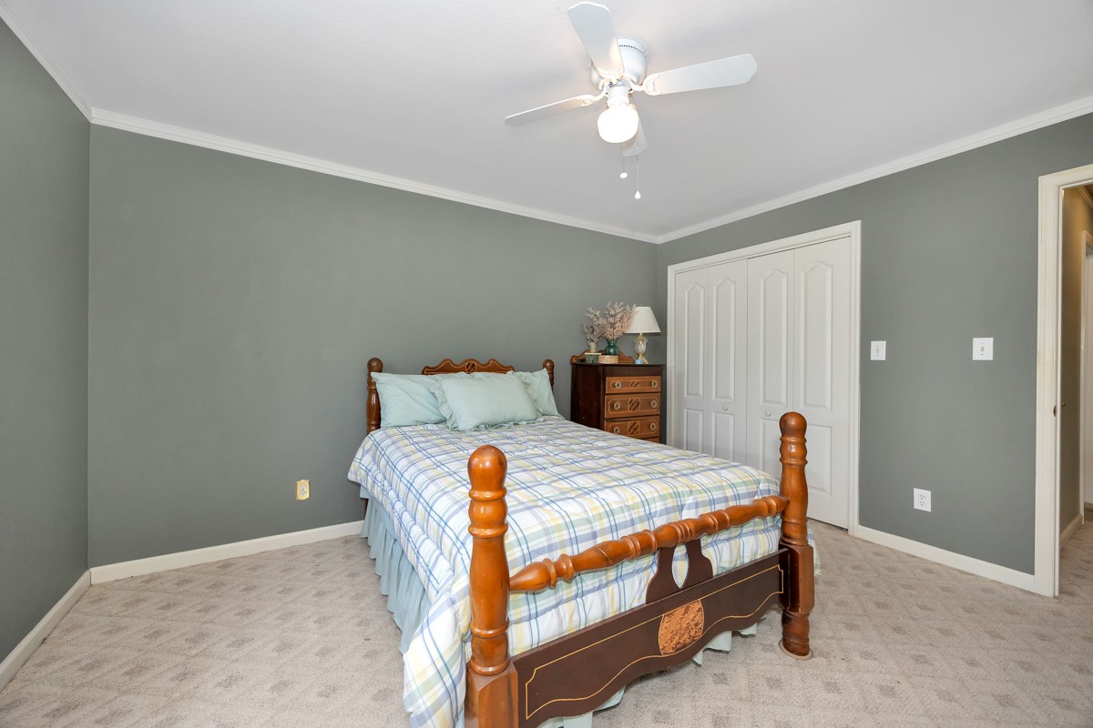 27615 Shannon Road Ardmore, AL 35739 - Photo 18 of 49 a bedroom with a bed and a chandelier