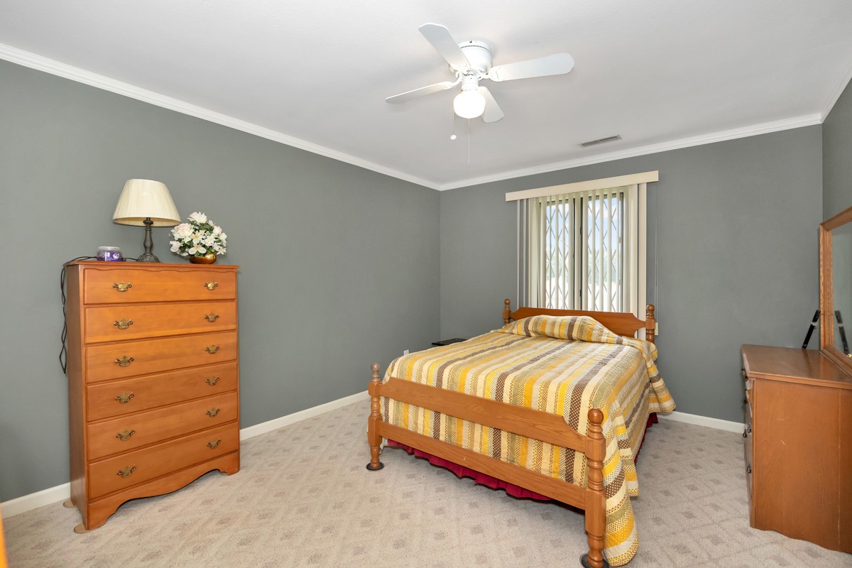27615 Shannon Road Ardmore, AL 35739 - Photo 19 of 49 a bedroom with a bed and a dresser