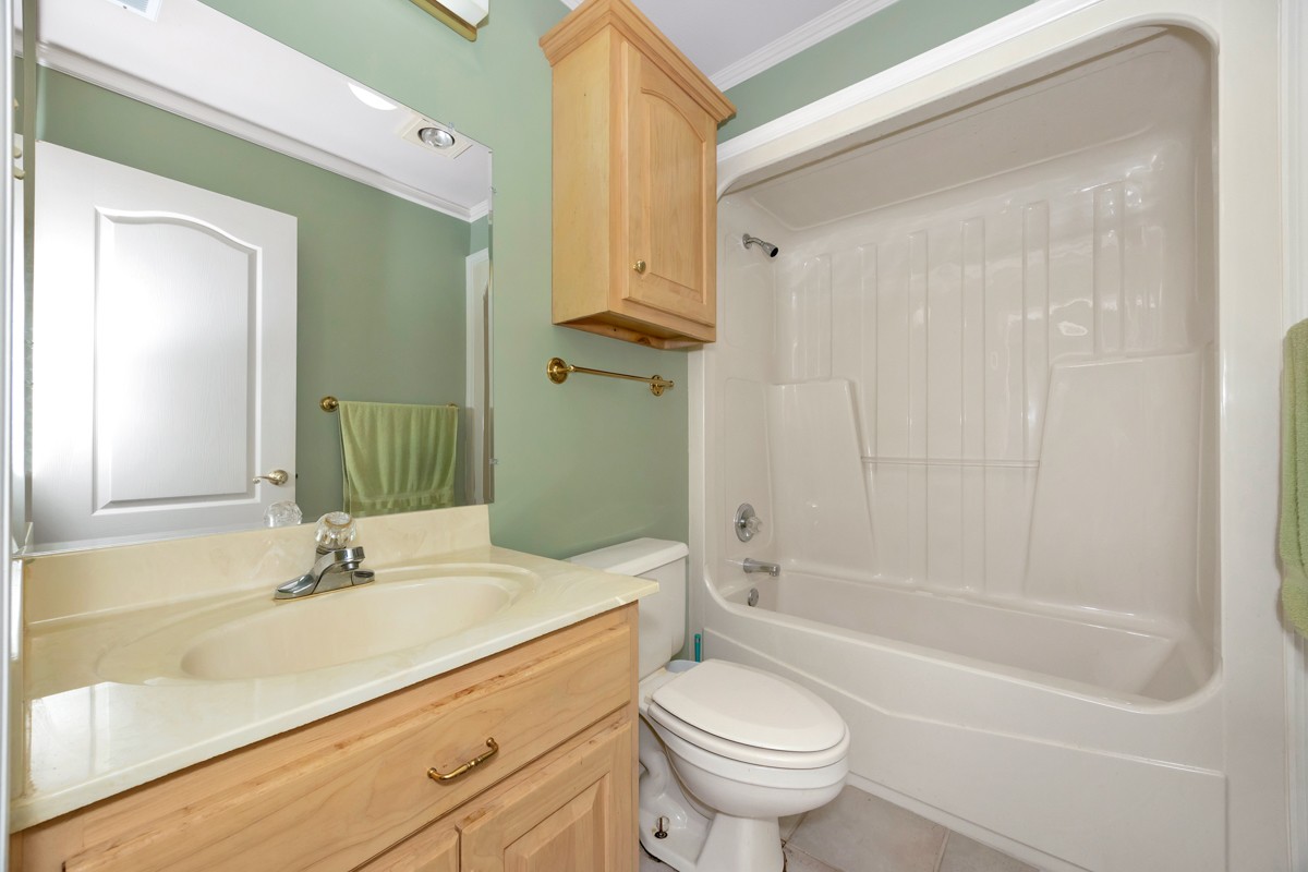 27615 Shannon Road Ardmore, AL 35739 - Photo 21 of 49 a bathroom with a granite countertop sink a toilet and shower