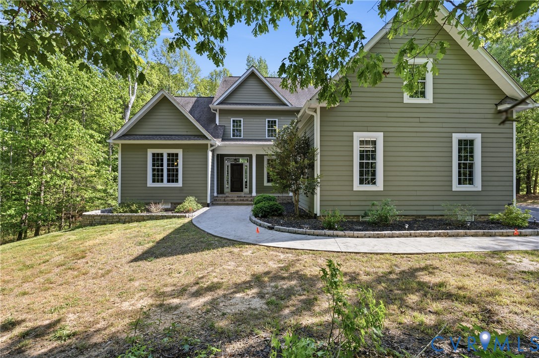 8825 First Branch Lane Chesterfield, VA 23838 - Photo 1 of 49 a front view of a house with a yard and garage