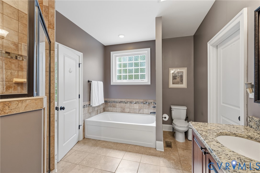 8825 First Branch Lane Chesterfield, VA 23838 - Photo 18 of 49 a spacious bathroom with a tub sink and mirror