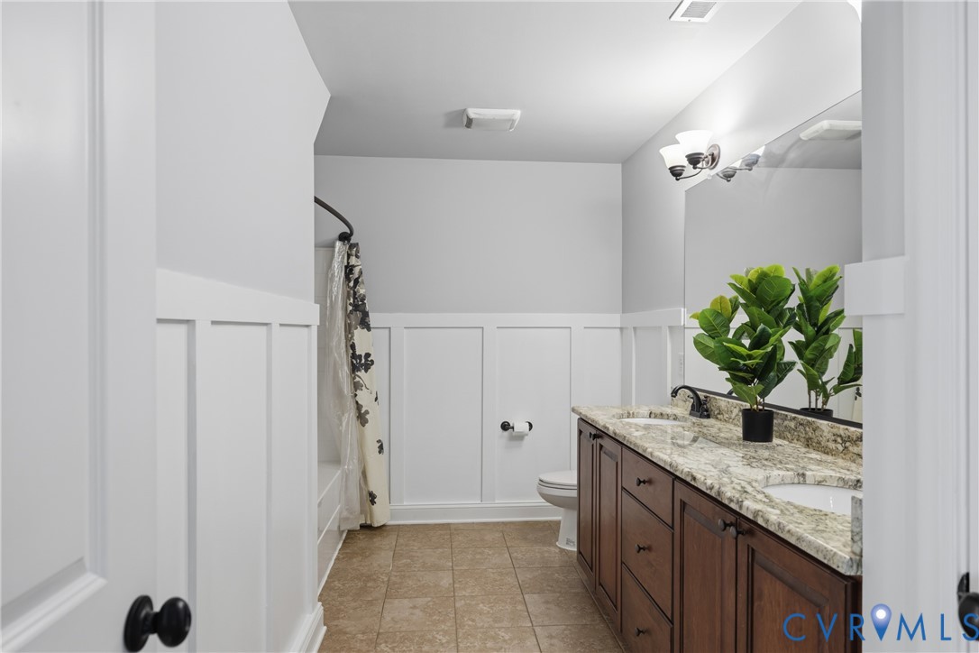 8825 First Branch Lane Chesterfield, VA 23838 - Photo 27 of 49 a bathroom with a granite countertop sink a mirror and a shower