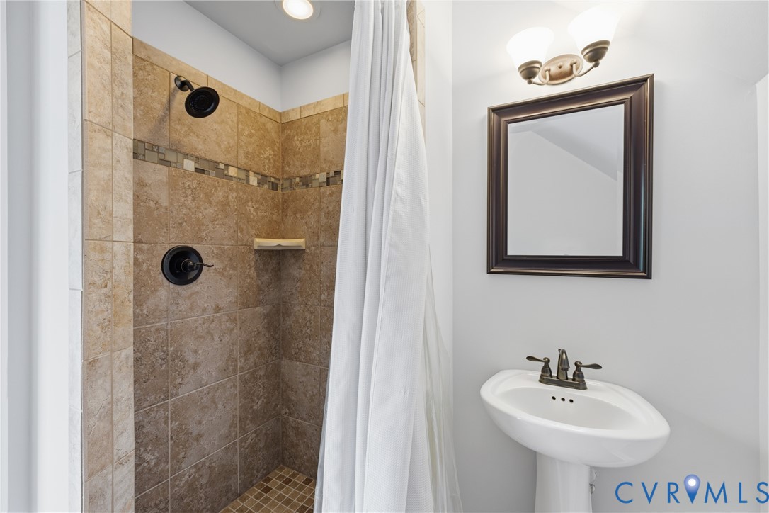 8825 First Branch Lane Chesterfield, VA 23838 - Photo 32 of 49 a bathroom with a sink mirror and shower
