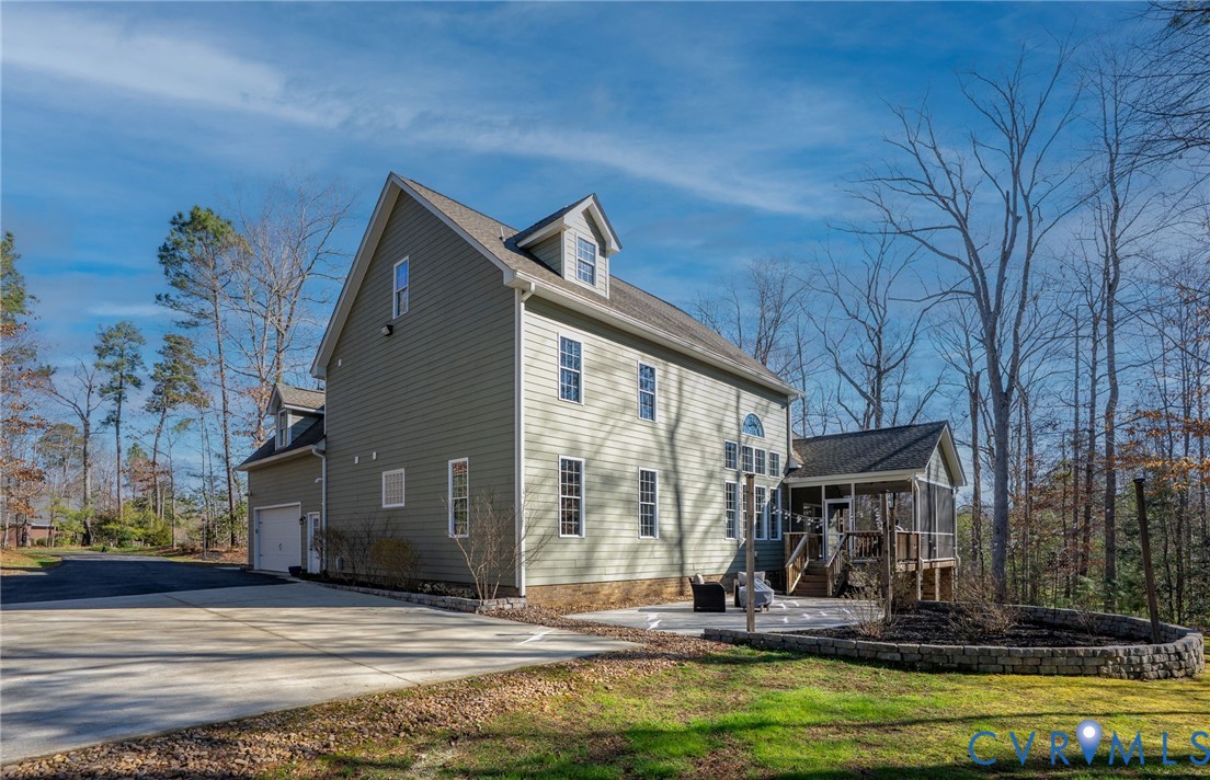 8825 First Branch Lane Chesterfield, VA 23838 - Photo 44 of 49 a view of a house with a small yard and floor to ceiling window and tree