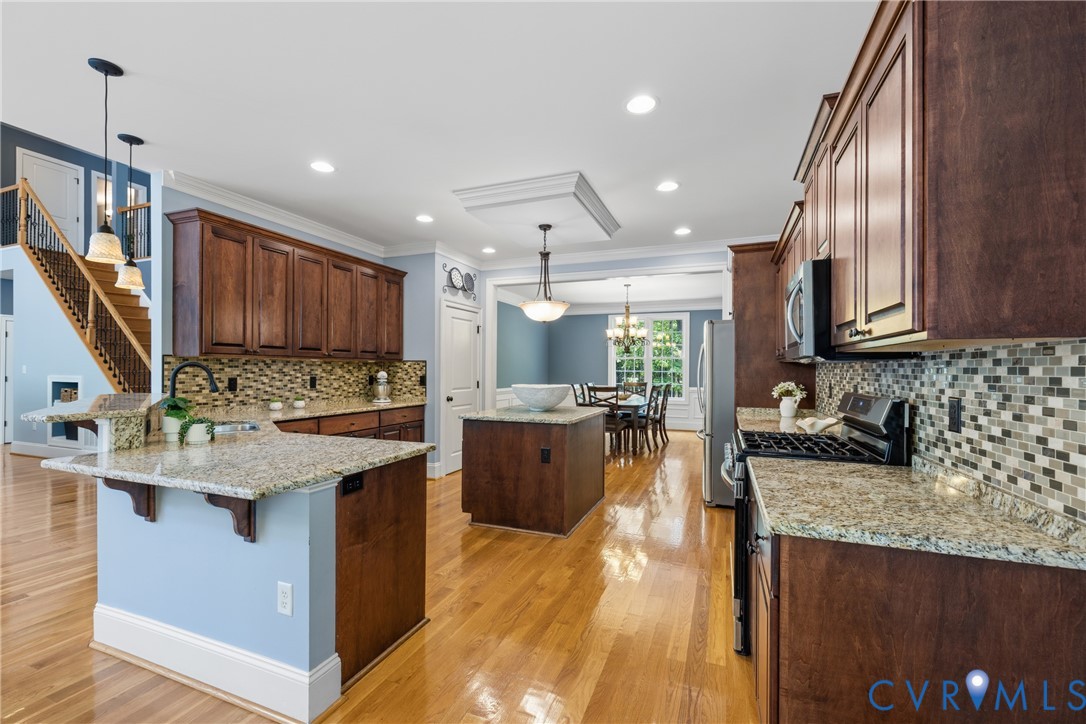 8825 First Branch Lane Chesterfield, VA 23838 - Photo 8 of 49 a kitchen with stainless steel appliances granite countertop a sink stove and refrigerator