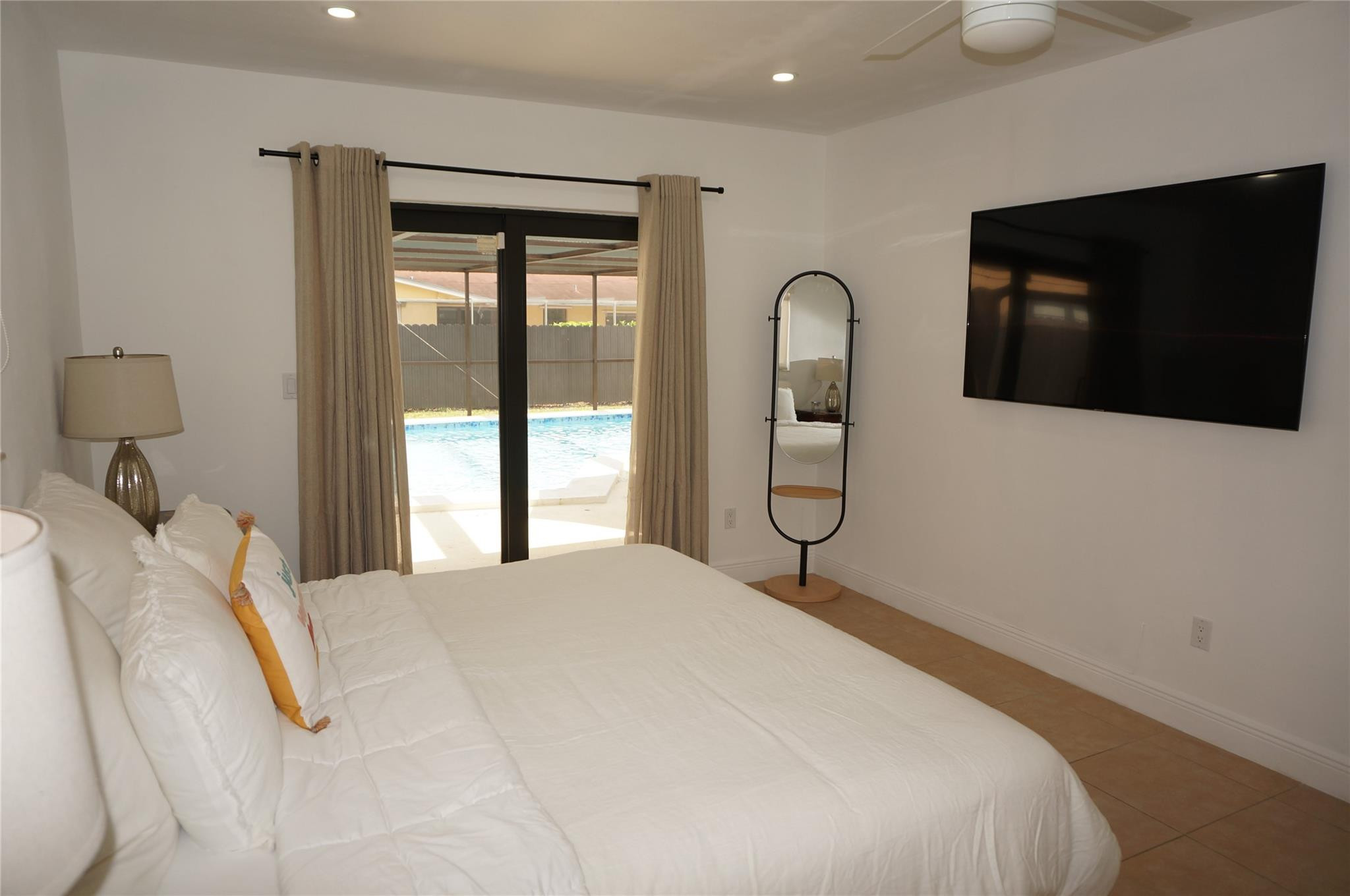 9220 Southwest 56th Street Miami, FL 33165 - Photo 13 of 23 a bedroom with a bed and a flat tv screen on dresser