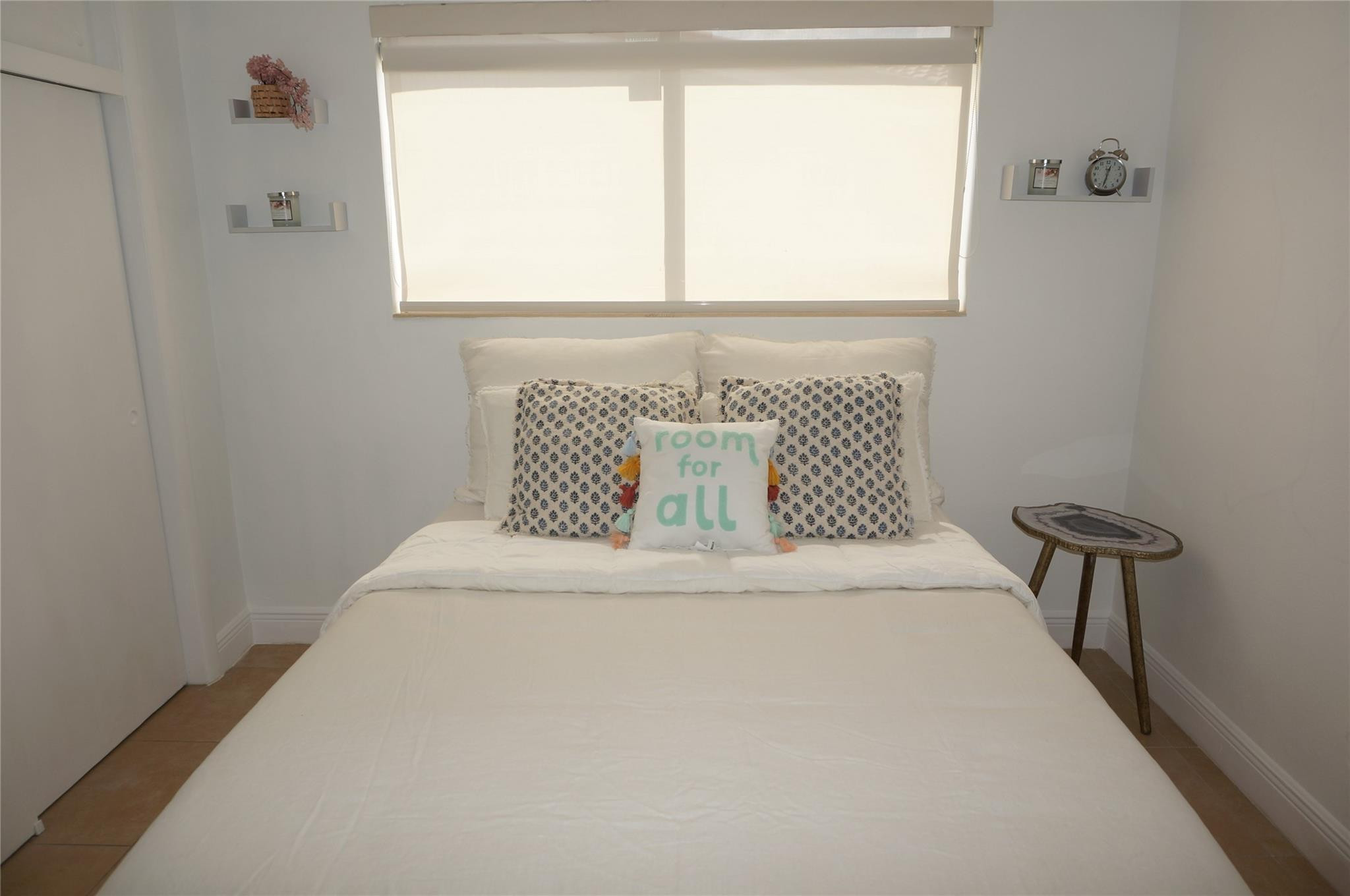 9220 Southwest 56th Street Miami, FL 33165 - Photo 17 of 23 a white bed sitting in a bedroom next to a window