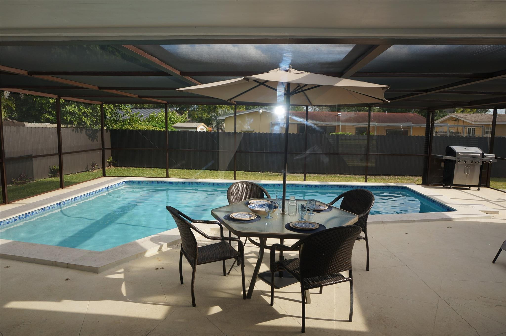 9220 Southwest 56th Street Miami, FL 33165 - Photo 20 of 23 a table and chairs in patio with a small yard