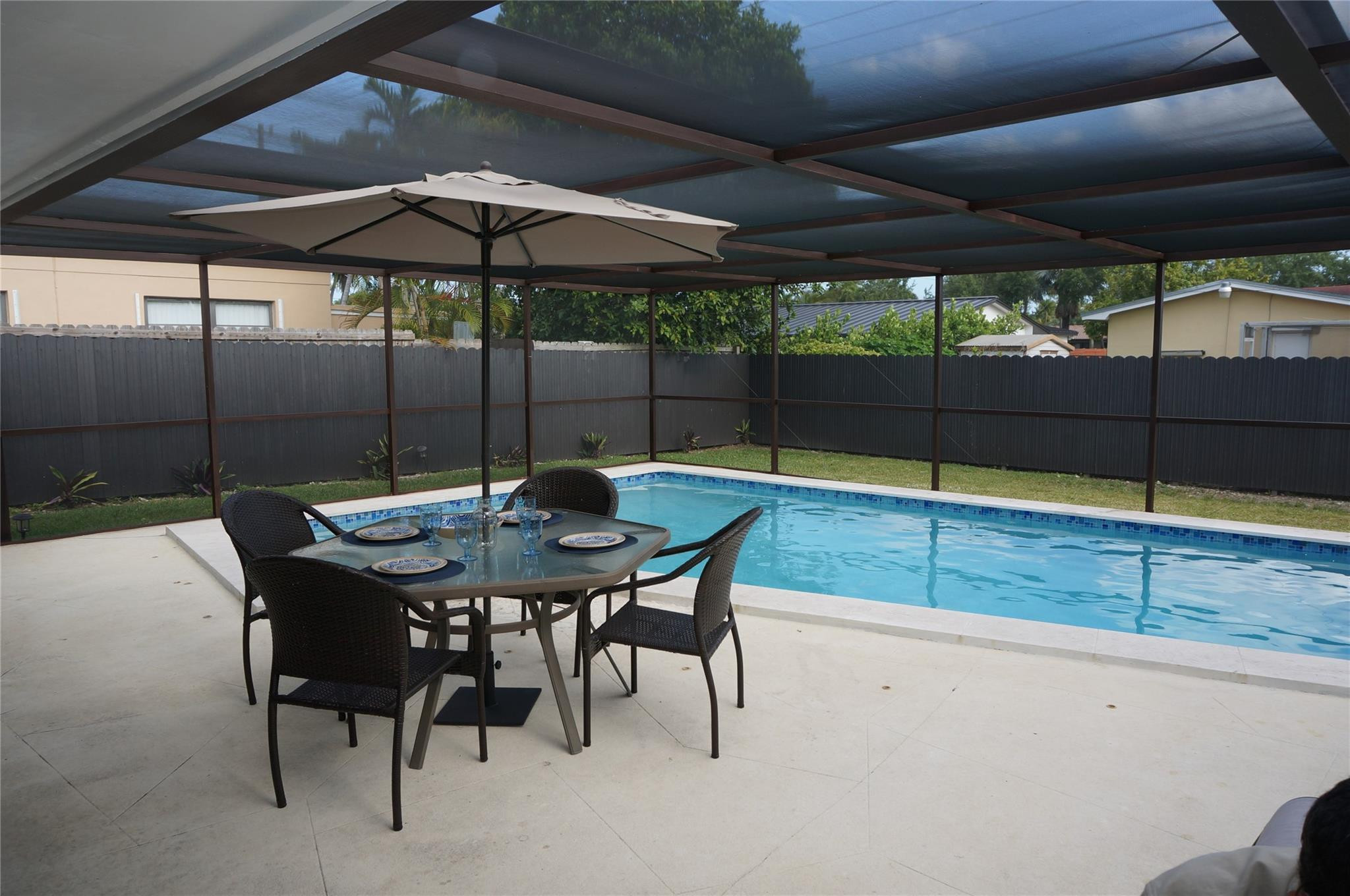 9220 Southwest 56th Street Miami, FL 33165 - Photo 21 of 23 a patio with a table and chairs