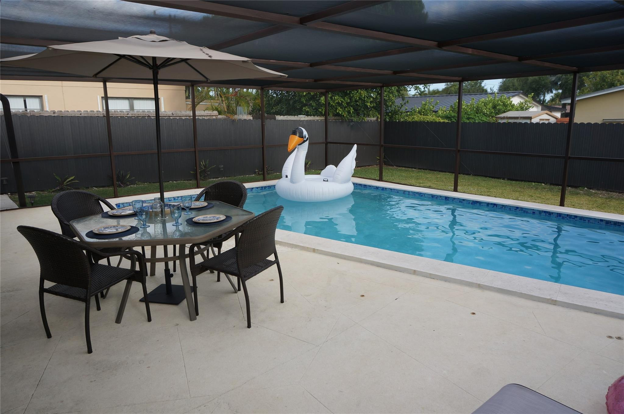 9220 Southwest 56th Street Miami, FL 33165 - Photo 23 of 23 a view of a patio with a table and chairs under an umbrella