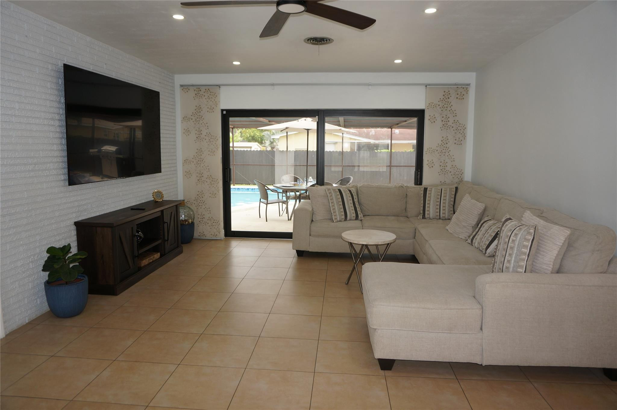 9220 Southwest 56th Street Miami, FL 33165 - Photo 5 of 23 a living room with furniture and a flat screen tv