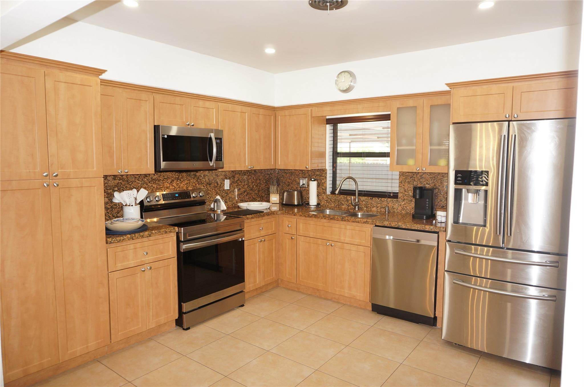9220 Southwest 56th Street Miami, FL 33165 - Photo 10 of 23 a kitchen with stainless steel appliances granite countertop a refrigerator stove and microwave