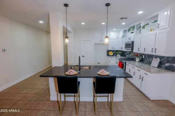 a kitchen with a table and chairs in it