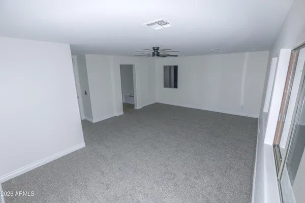 a view of walk in closet with empty racks