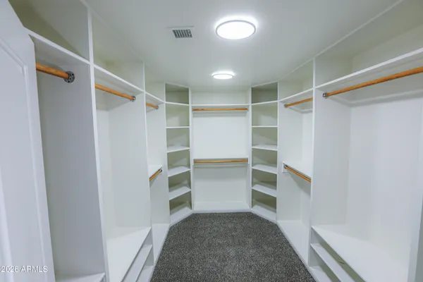 an empty room with a ceiling fan and a window