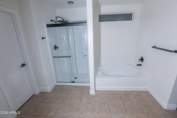 a bathroom with a double vanity sink a mirror and a shower